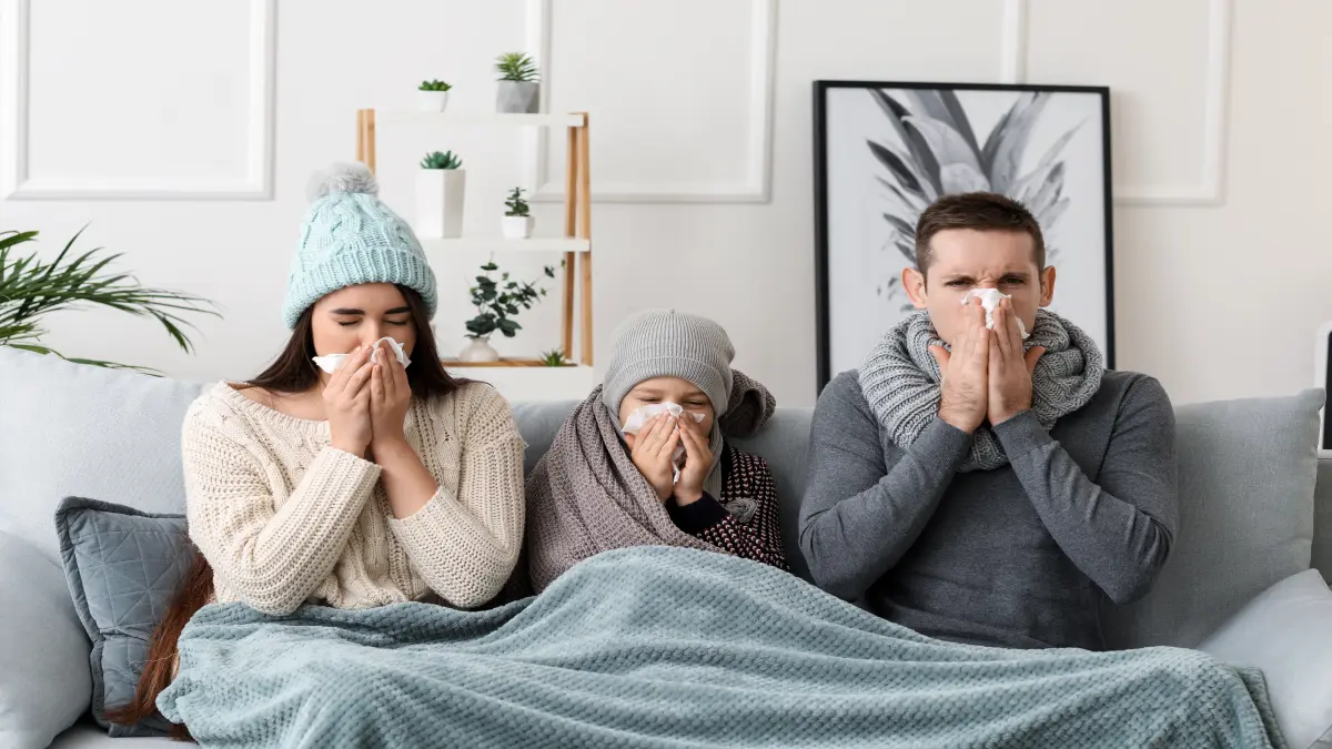 Mutter, Vater und Kind auf Sofa, die Erkältet sind