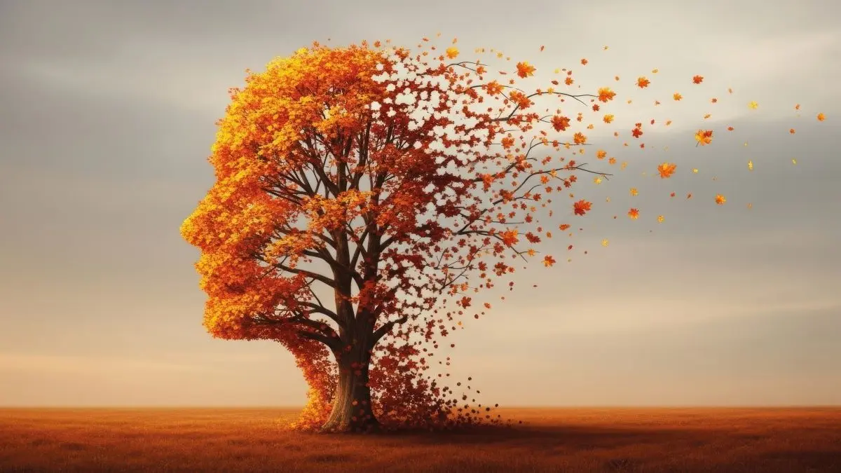 Symbolisches Bild für Demenz: Ein Baum in Form eines Kopfes verliert seine Blätter, die vom Wind verweht werden. © Meow Creations – stock.adobe.com