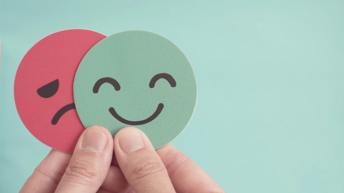 Ein lachender und ein weinender Smiley sind übereinander gelegt.